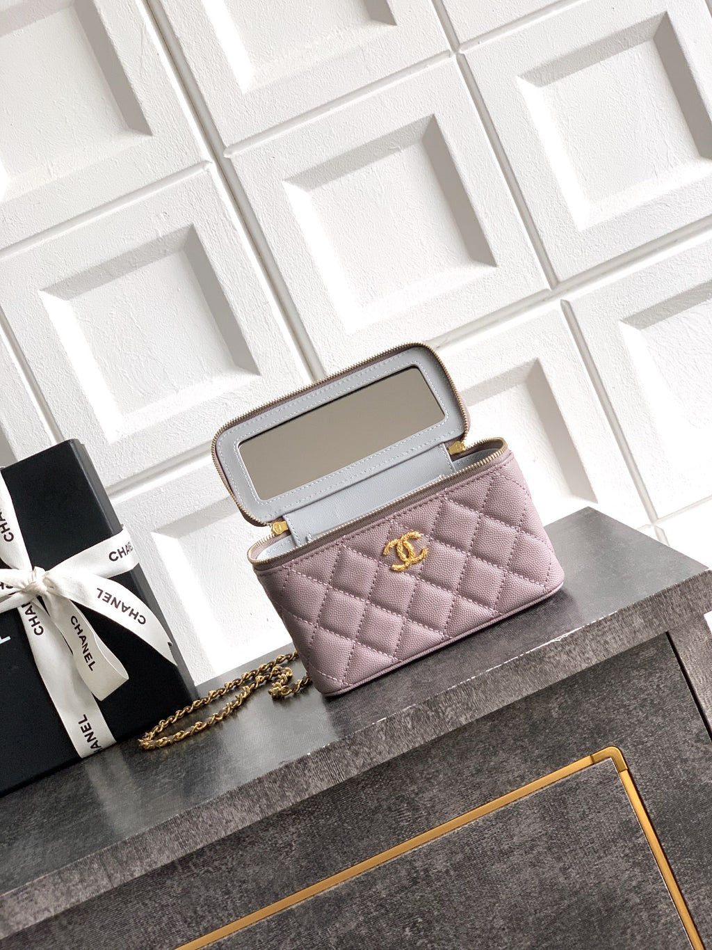 Lilac quilted mini bag open with inner compartments and gold-tone chain