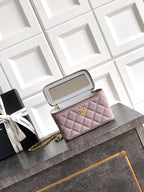 Lilac quilted mini bag open with inner compartments and gold-tone chain