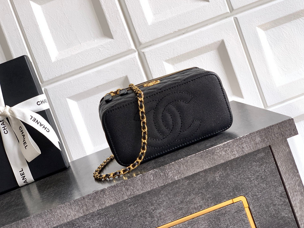 Chanel quilted leather mini bag, black, with gold chain and logo front clasp.