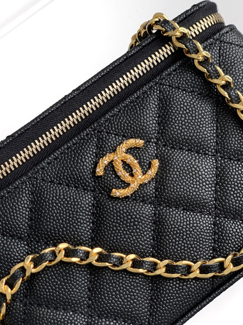 Chanel quilted mini bag interior, gold zipper and CC logo emblem on lining.