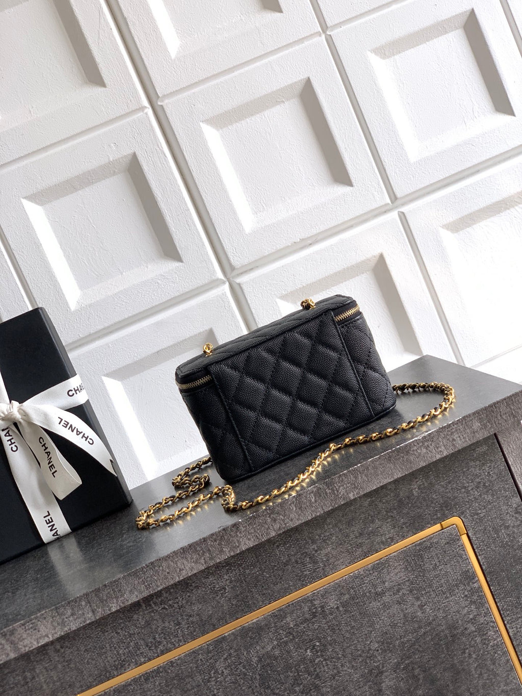 Chanel quilted leather mini bag, black, gold chain strap and front flap details.