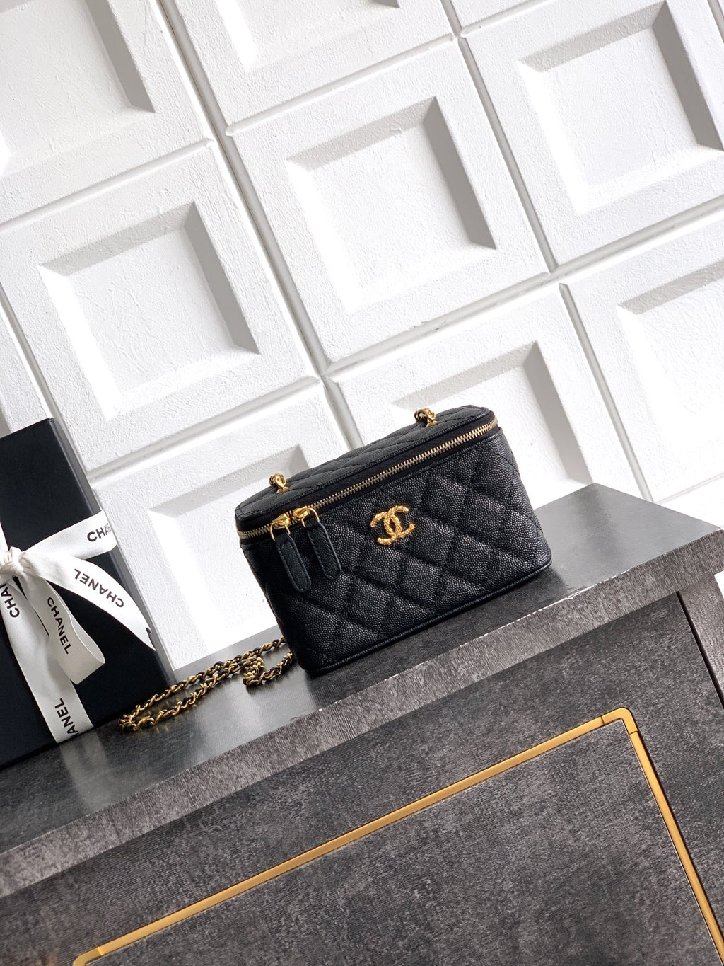 Chanel quilted leather mini bag, black, with gold-tone chain strap and CC emblem.