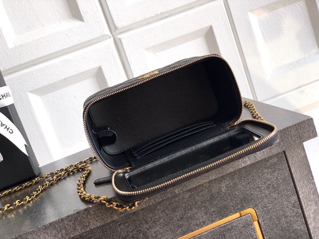 Chanel mini bag with open flap, black quilted leather and gold-tone chain strap.