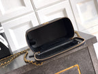 Chanel mini bag with open flap, black quilted leather and gold-tone chain strap.