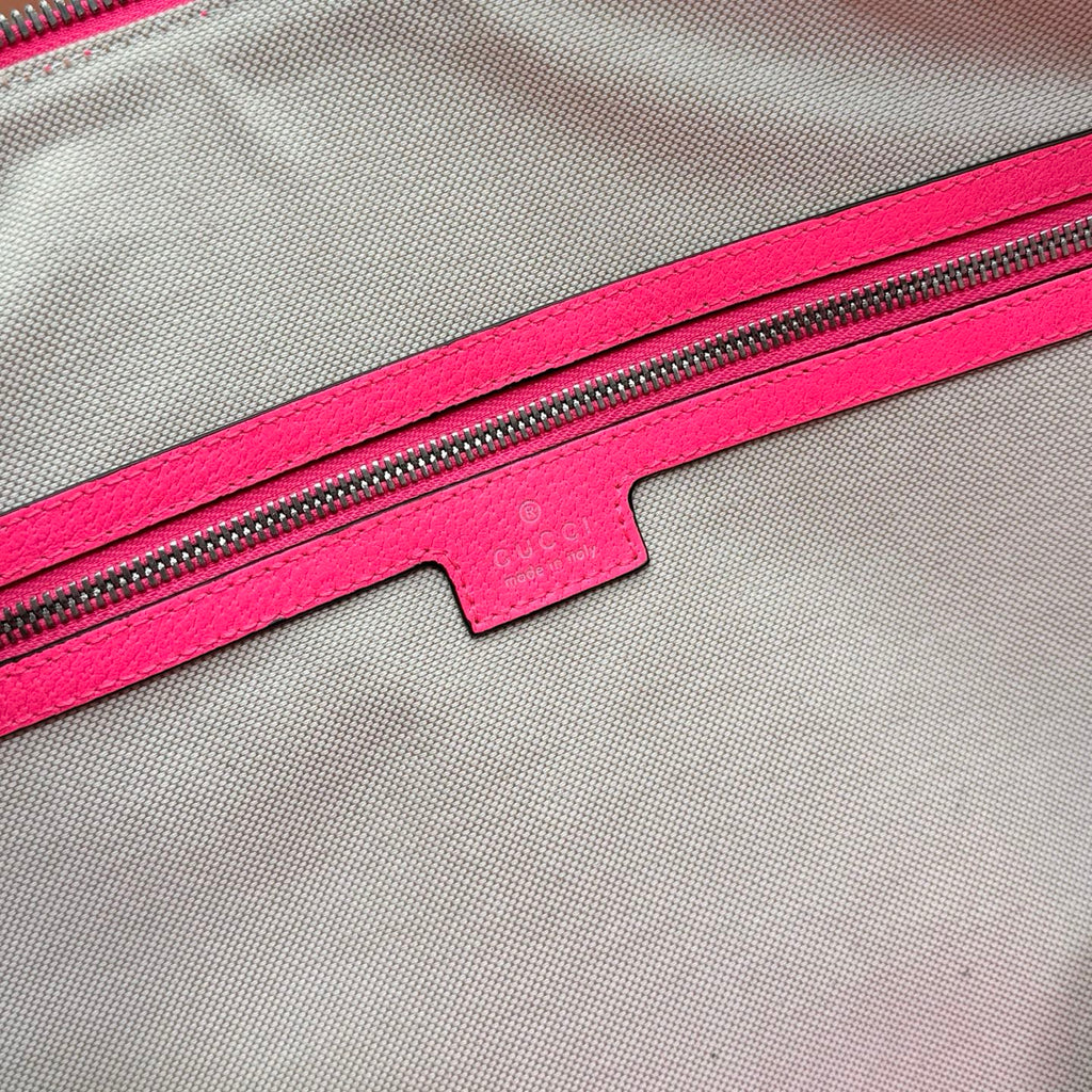 Gucci duffel bag zipper area with pink lining and small fabric logo label