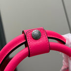 Gucci duffel bag strap end with round metal logo plate, pink leather