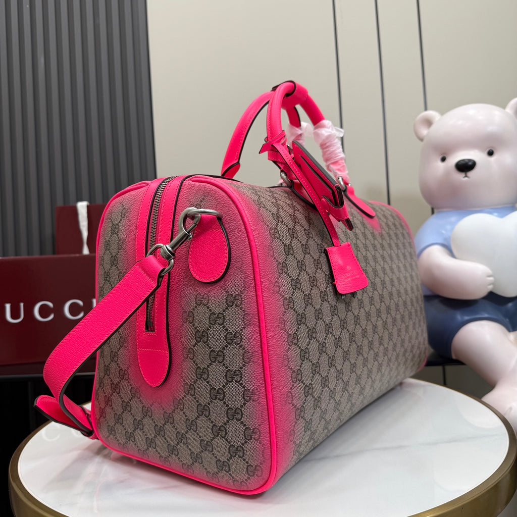 Gucci duffel bag side view with pink strap, GG canvas, and metal hardware