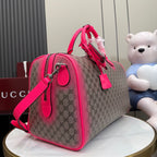 Gucci duffel bag side view with pink strap, GG canvas, and metal hardware
