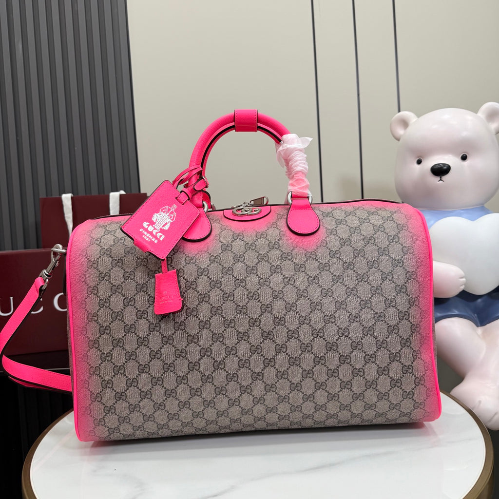 Gucci duffel bag with GG canvas and bright pink leather trim, top handles