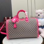 Gucci duffel bag with GG canvas and bright pink leather trim, top handles