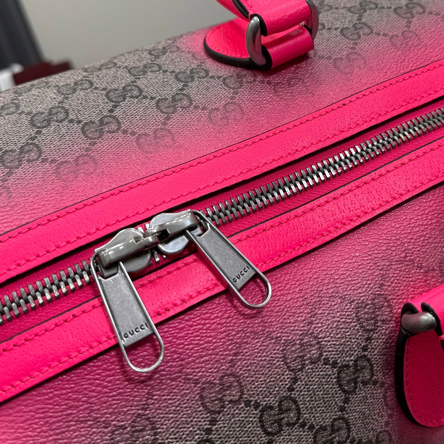 Gucci duffel bag zipper track with metal pull hardware and pink leather edging