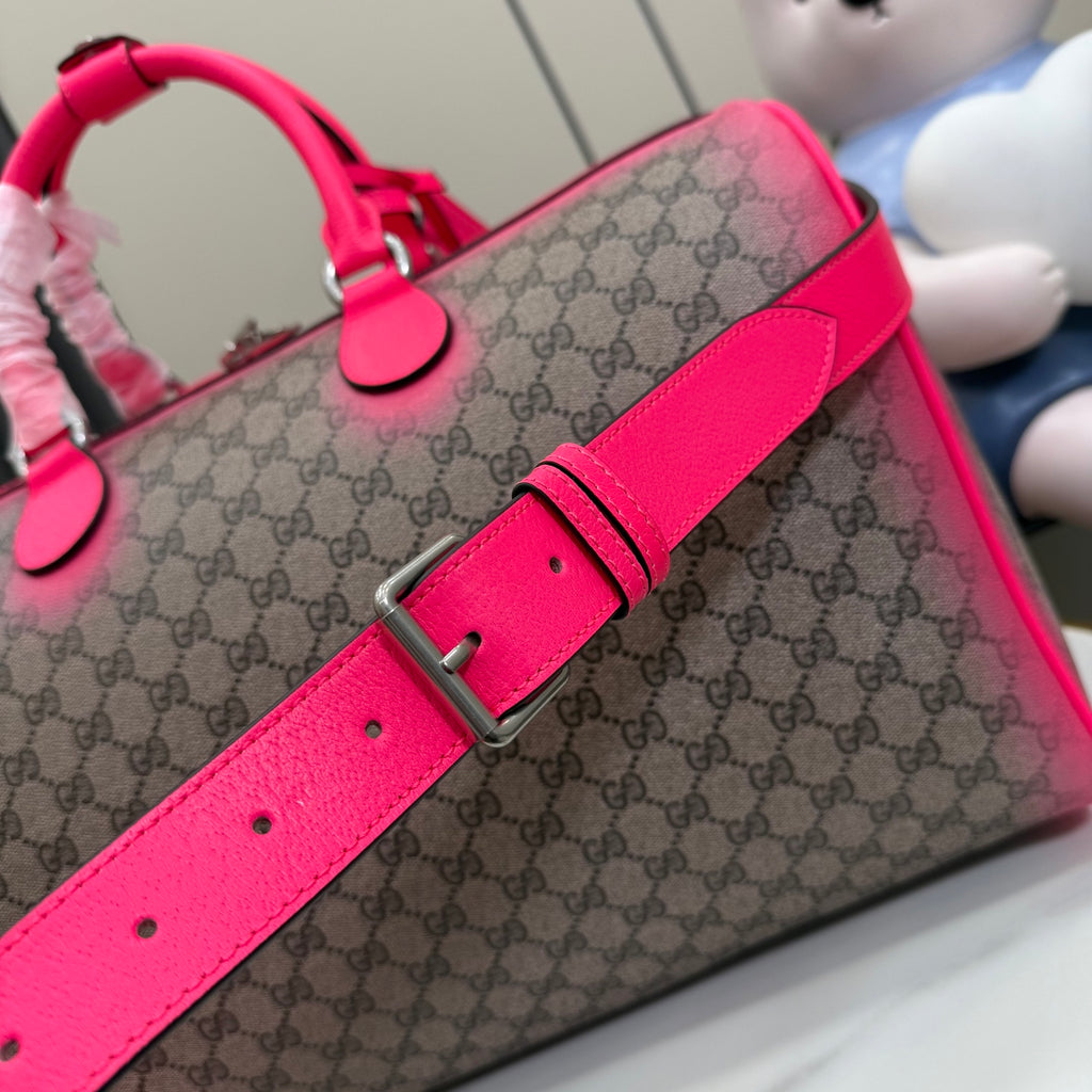 Gucci duffel bag crossbody strap with silver buckle and bright pink leather tab