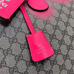 Pink leather Gucci bag key fob with logo stamp on GG-pattern canvas