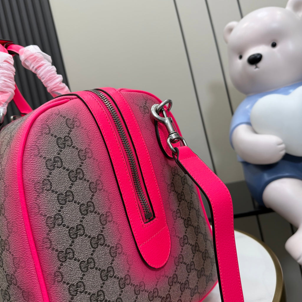 Pink Gucci bag with GG monogram canvas, leather trim, and top zipper pocket