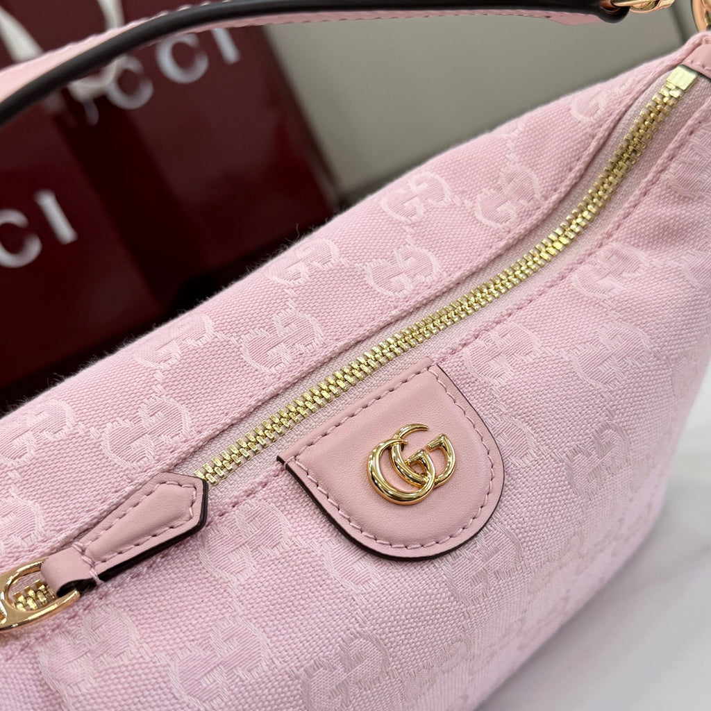 Light pink monogram pouch with gold zipper and snap front logo patch