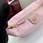 Light pink mini bag with gold zipper pull and front snap logo patch