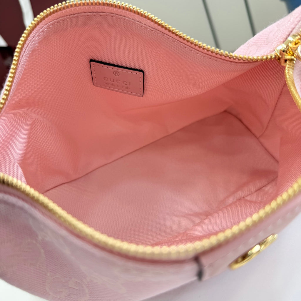 Pink fabric-lined bag interior with gold zipper trim