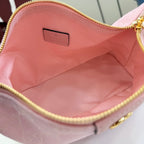 Pink fabric-lined bag interior with gold zipper trim