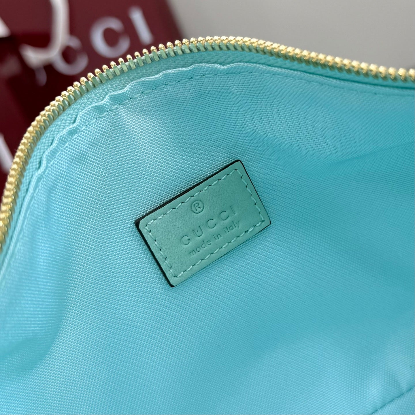 Gucci light blue interior lining with rectangular logo patch and stitched edges