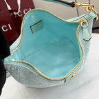 Gucci bag interior in light blue with zipper opening and small logo patch