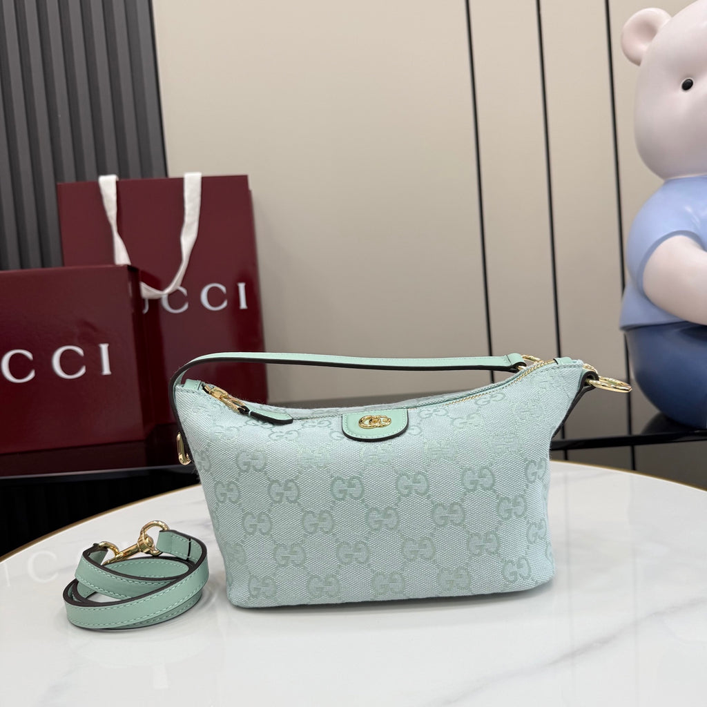 Gucci shoulder bag in light blue with GG monogram canvas, gold hardware, top zip