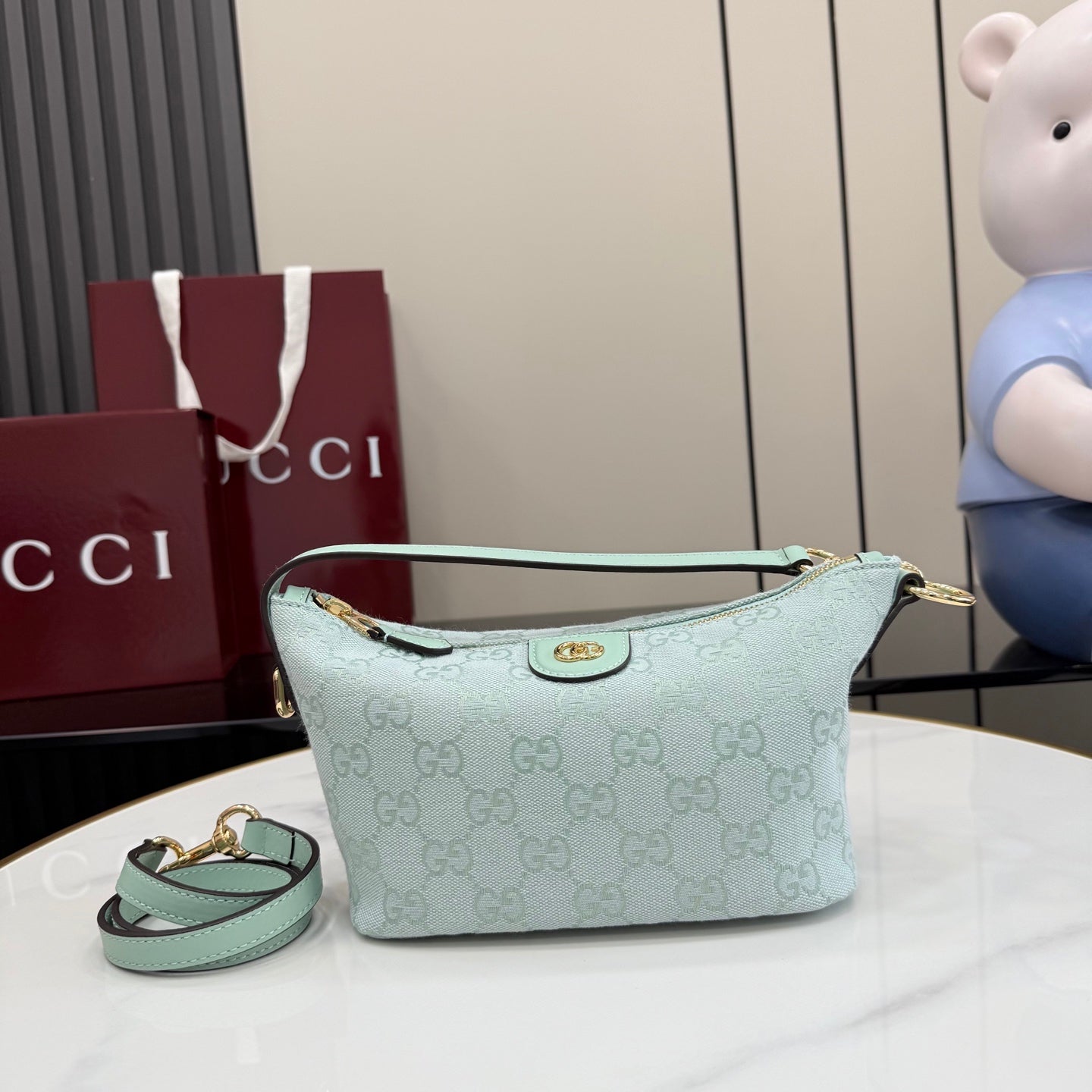 Gucci shoulder bag in light blue with GG monogram canvas, gold hardware, top zip