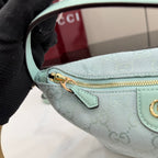 Gucci light blue GG monogram bag close-up of top strap attachment and gold zipper