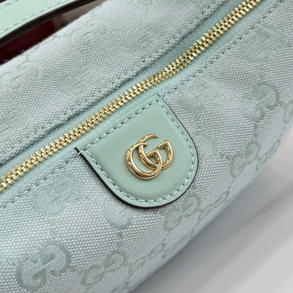 Gucci light blue GG monogram zip pouch detail with gold zipper and logo patch