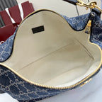 Gucci GG canvas bag interior view with beige lining and gold-trim zipper edge.