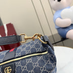 Gucci GG canvas shoulder bag close-up of strap hardware with gold rings and leather ends.