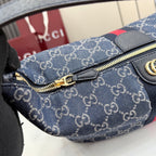 Gucci GG canvas bag close-up: gold zipper pull and side leather hardware accents.