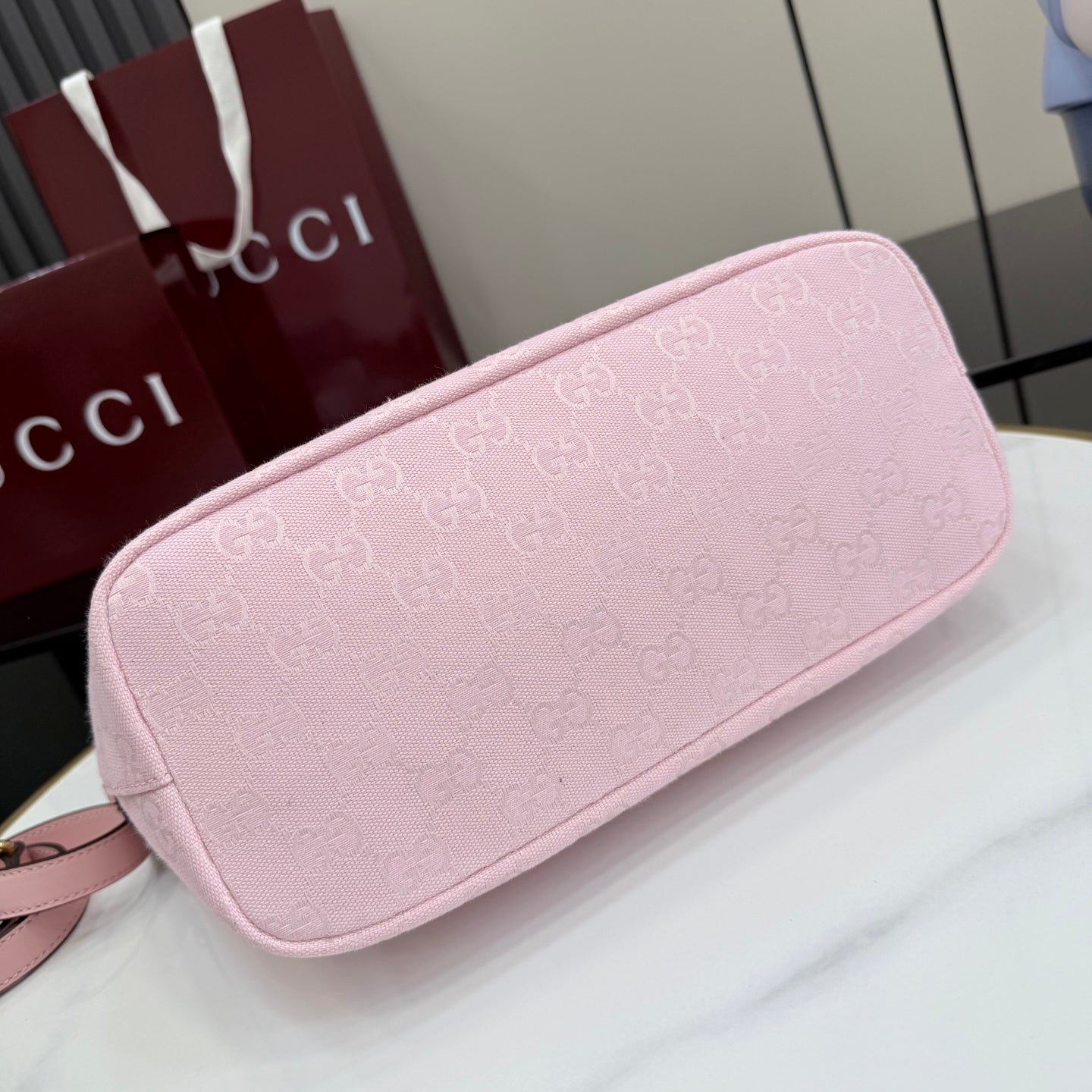 Pink GG monogram bag, rounded back panel, gold zip edge, leather trim.