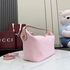 Pink GG monogram hobo bag, gold hardware, leather trim, adjustable strap, zip top.