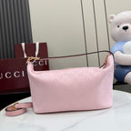Pink GG monogram shoulder bag with curved silhouette and gold zip-top hardware.