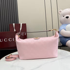 Pink shoulder bag with GG monogram, gold-tone chain strap, zip-top closure.