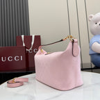 Pink GG monogram mini bag with top handle, gold-tone chain strap, zip closure.