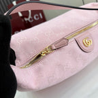 Pink GG monogram bag with gold zipper and leather zipper pull tab.