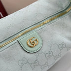 Gucci hobo bag detail: gold zipper and light blue logo leather patch on GG monogram