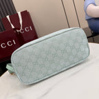 Light blue Gucci hobo bag with GG monogram canvas and rounded side profile, gold trim