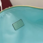 Gucci hobo bag detail: teal fabric lining with small light blue Gucci logo patch