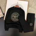 Black sweatshirt and jogger set with gold Medusa logo print and circular chest graphic