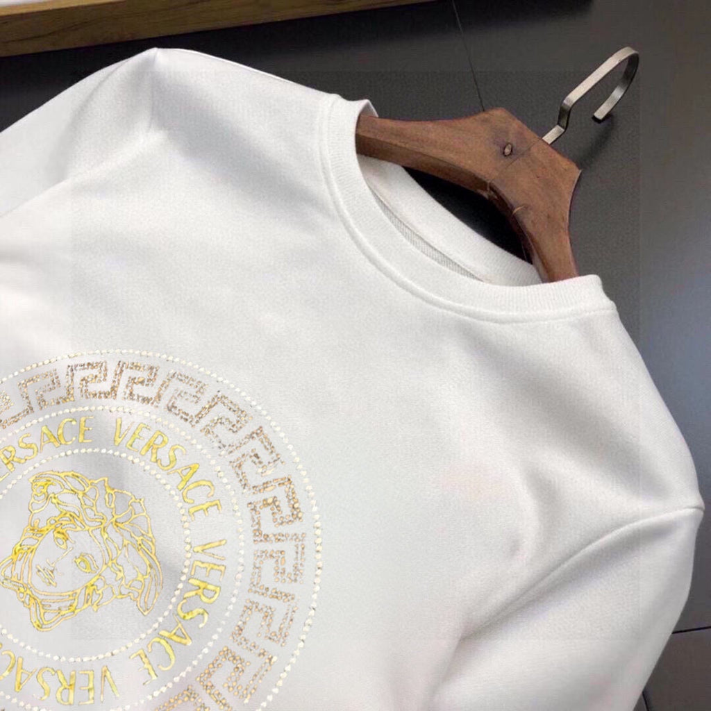 White sweatshirt with gold Medusa logo graphic across the chest