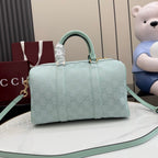 Mint GG-pattern handbag with structured top, stitched panels, and adjustable mint shoulder strap.