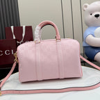 Gucci pale pink duffle bag with G monogram print, rounded handles and long strap