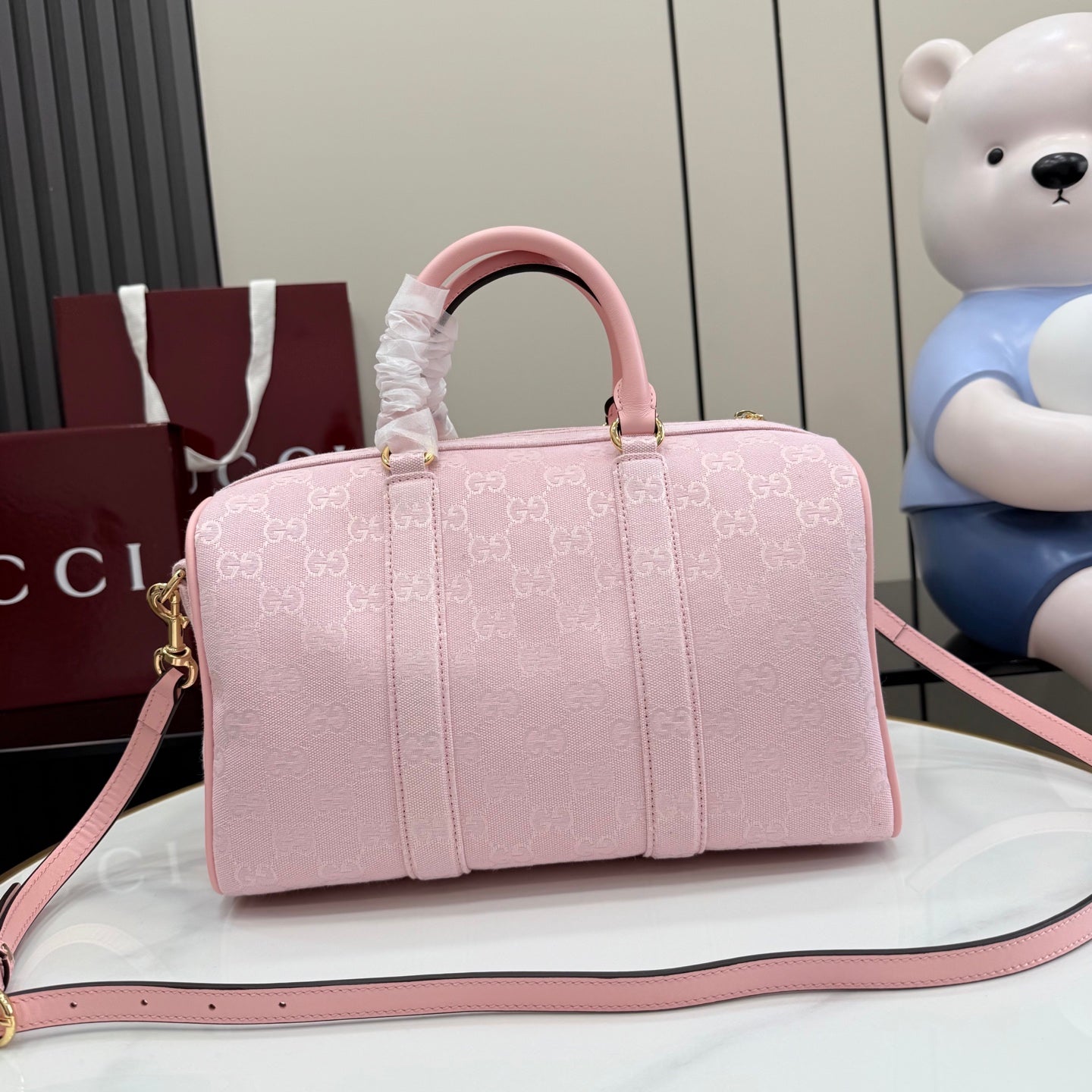 Gucci pale pink duffle bag with G monogram print, rounded handles and long strap