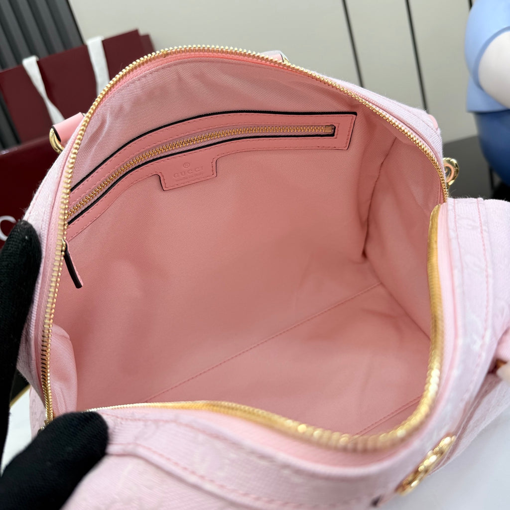 Gucci pale pink bag interior view with zip opening and logo patch on lining