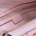 Gucci pale pink bag close-up of leather patch logo and gold zipper track