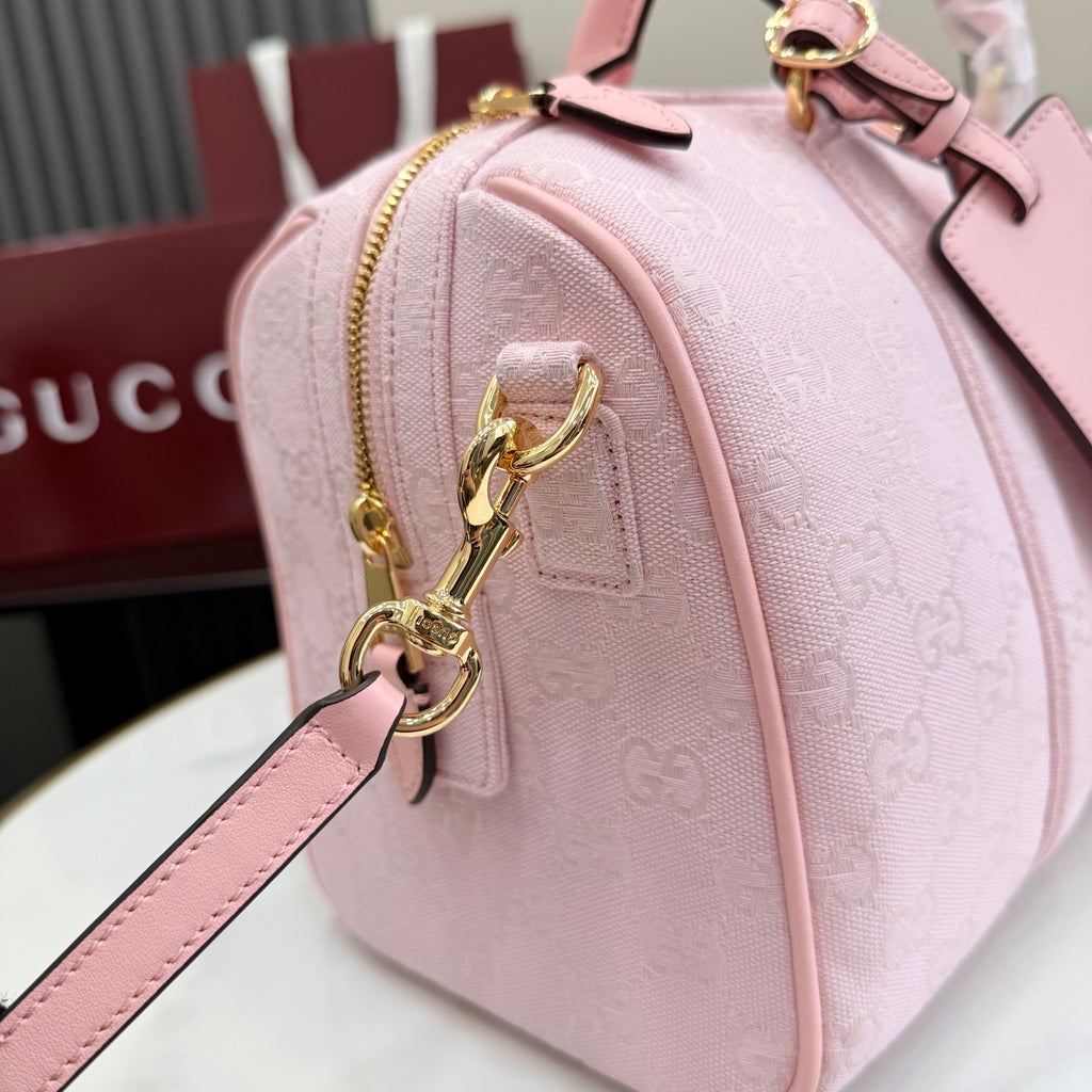 Gucci pale pink bag with G monogram print, front zip pocket and gold key clasp charm