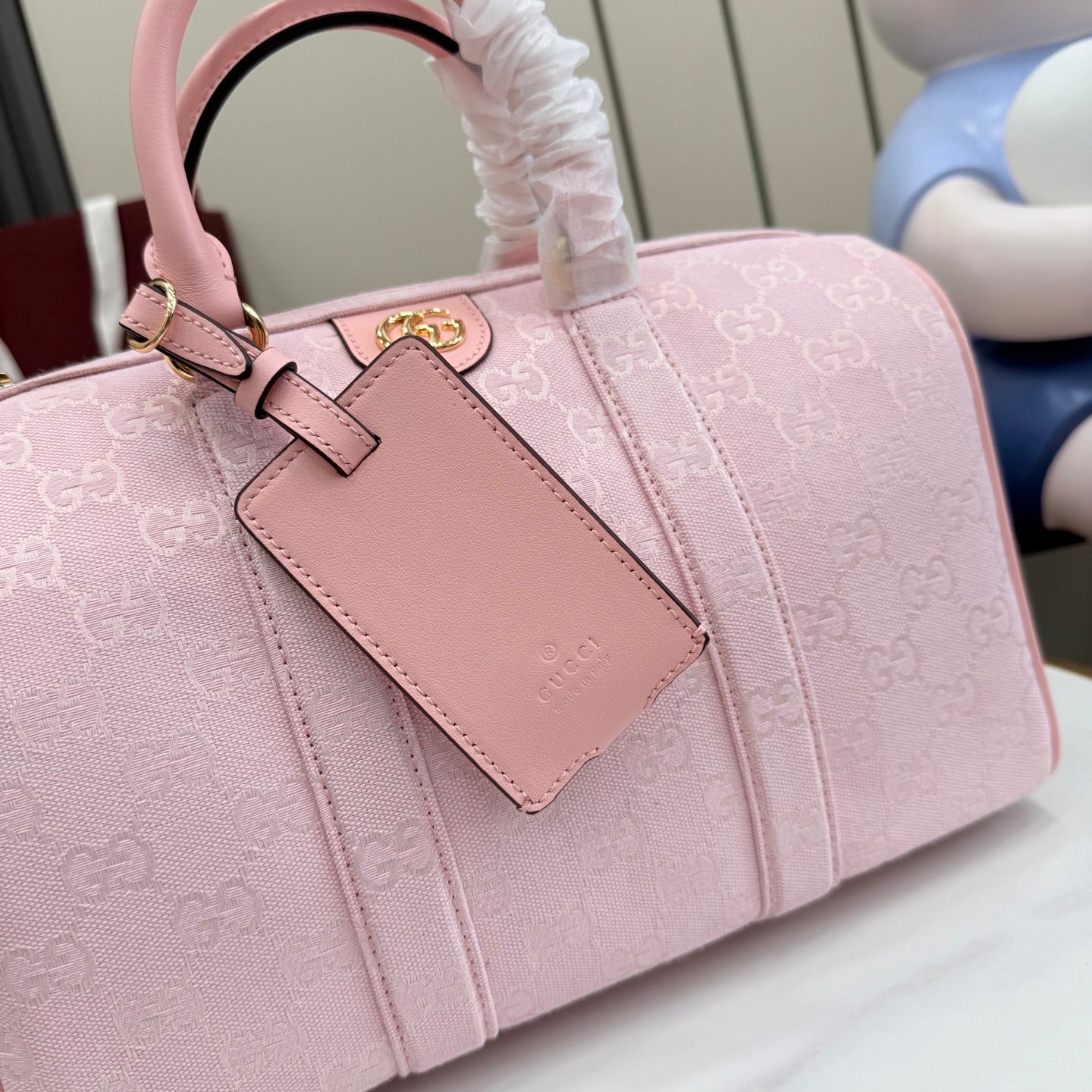 Pink Gucci GG canvas handbag with leather top handle and front logo pocket