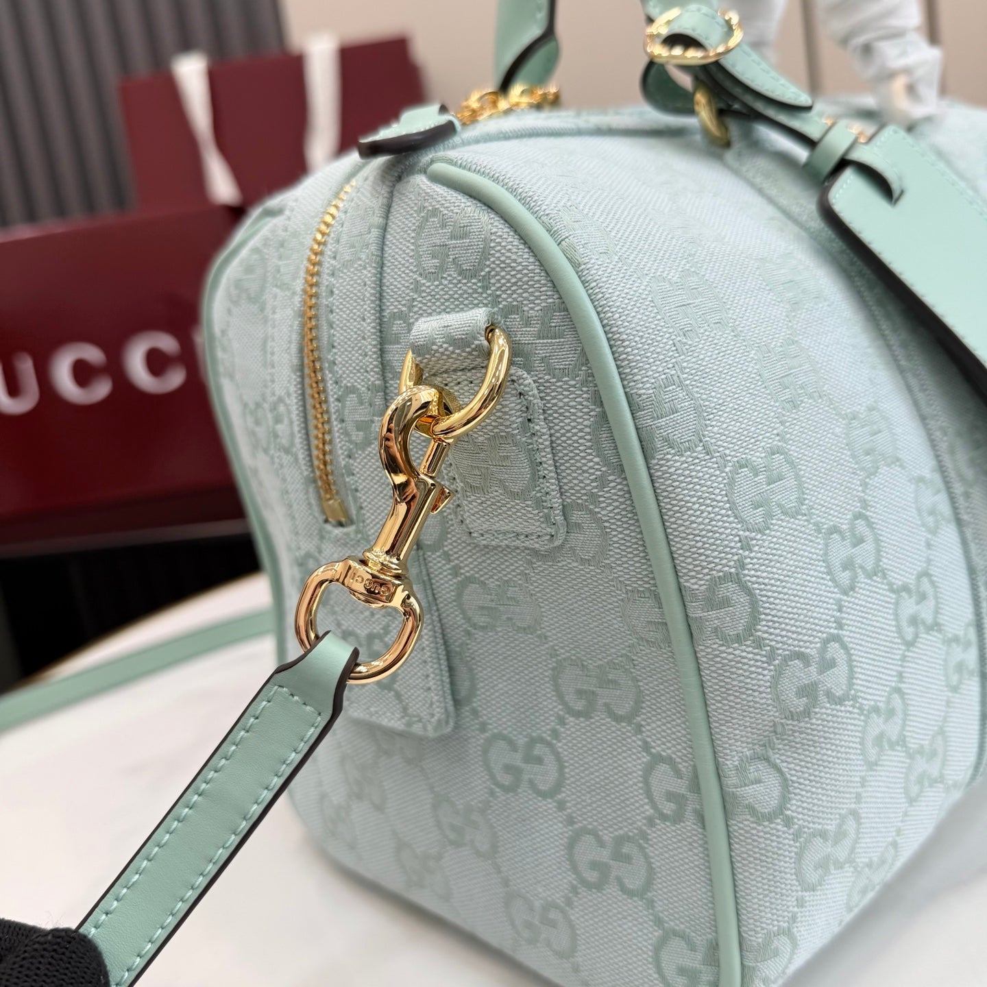 Gucci handbag in light blue with GG monogram, gold hardware and zipper pull